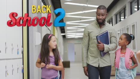 animation of back 2 school text over happy diverse male teacher and schoolgirls talking in corridor