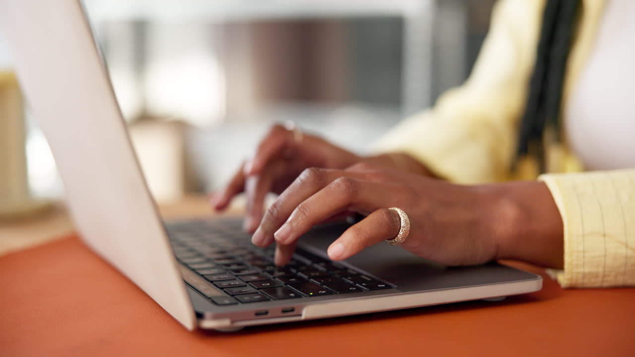 Close-up of Hands Typing on Laptop Keyboard