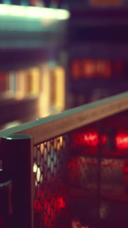 closeup of a metal fence with blurred lights in the background