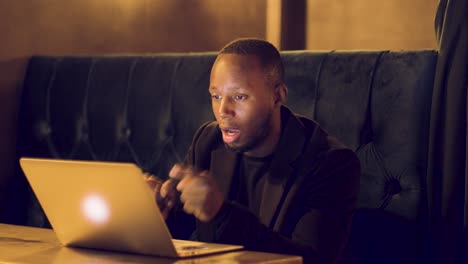 Professional-male-boss-talking-aggressively-on-a-video-call-in-a-booth