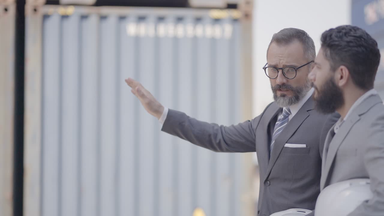 experto, socio comercial, caminando y hablando de tratar de trabajar juntos o haber acordado la inversión en un nuevo proyecto en el transporte de carga en el patio de carga de contenedores. colaboración en negocios.