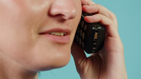 woman talking on an old cell phone