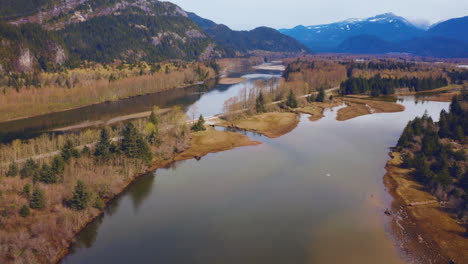 Scenic-autumn-aerial-drone-view-flying-over-a-river-in-the-mountain-wilderness-of-British-Columbia