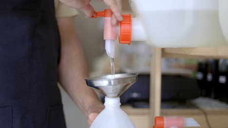 person pouring soap from dispenser