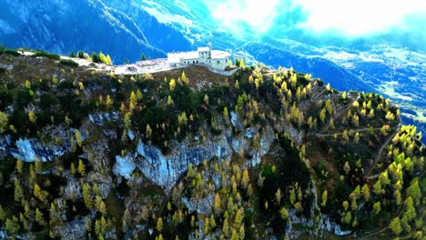 aerial view of winding mountain road snaking through lush green valley