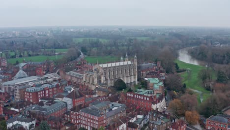 rotating aerial drone shot of eton college chapel on a cloudy day