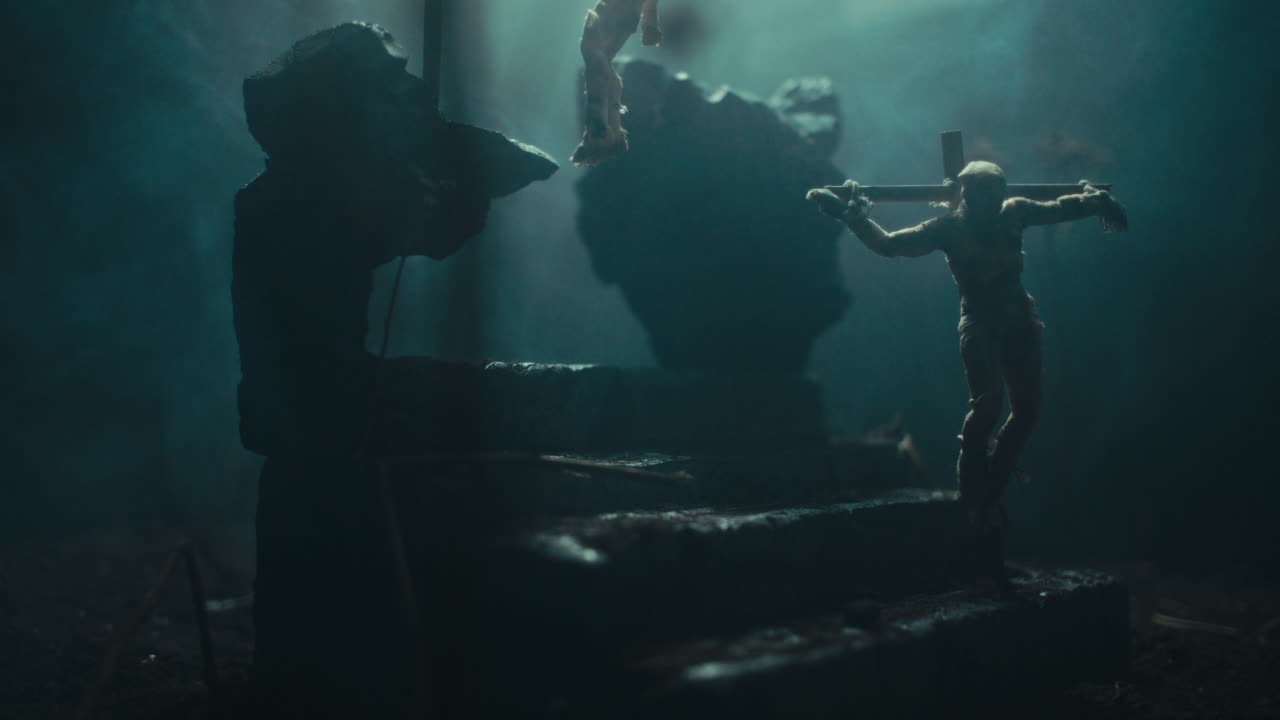 Miniature mummified dolls hanging on the gallows at night