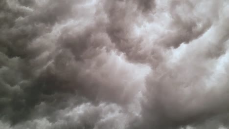 Dark-Grey-Clouds-Billowing-In-Dramatic-Sky---low-angle,-timelapse