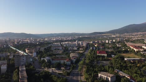 drone shot, of the outskirts of sofia, the capital city of bulgaria, on a bright summer day with a clear blue sky, close to vitosha mountian