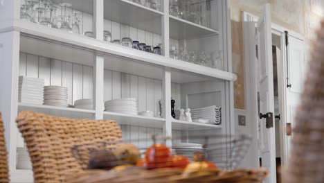 Rotating-shot-of-kitchen-utensils-and-crockery-on-display-in-a-open-cupboard