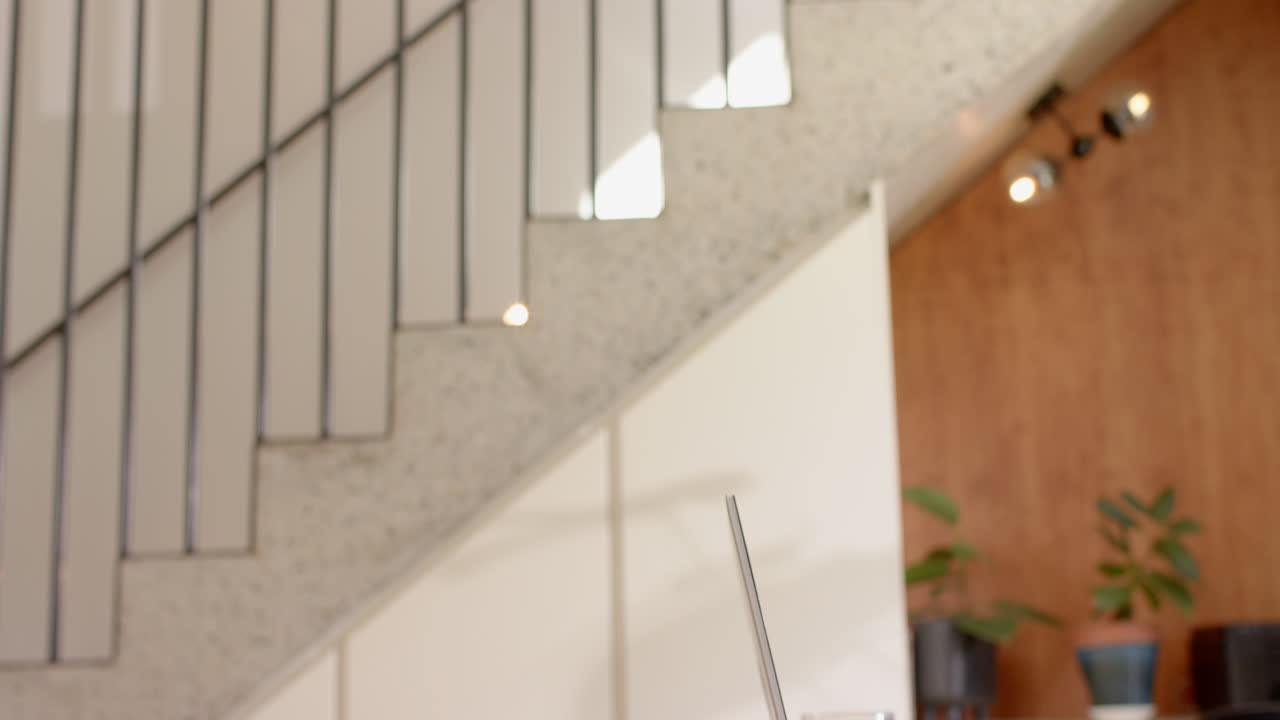 Enjoying drinks, female friends hanging out together in modern home setting, copy space