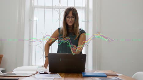 Animation-of-multicolored-graphs-over-thoughtful-caucasian-woman-looking-at-laptop-screen