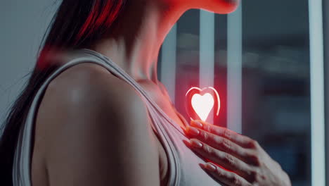 woman holding a glowing heart