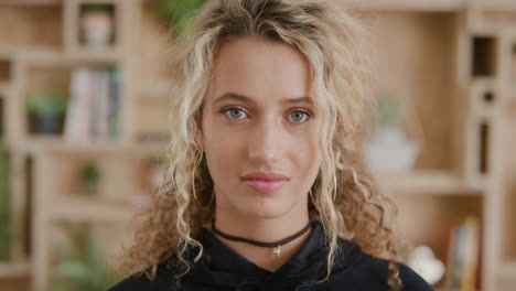 close up portrait of attractive young blonde woman looking serious at camera attractive female student