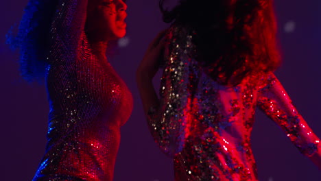 Close-Up-Of-Two-Women-In-Nightclub-Bar-Or-Disco-Dancing-With-Sparkling-Lights-19