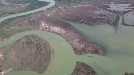 river meanders through the lagoon bringing the turbid water, breaks banks and spreads, flooding the lands in albania