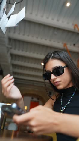 woman using mobile phone in a cafe