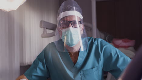 medical professional in full ppe preparing for procedure