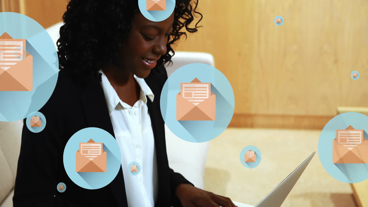 Animation of letter and envelope icons in circles, african american woman working on laptop