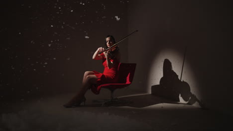 woman playing violin in red dress, studio setting