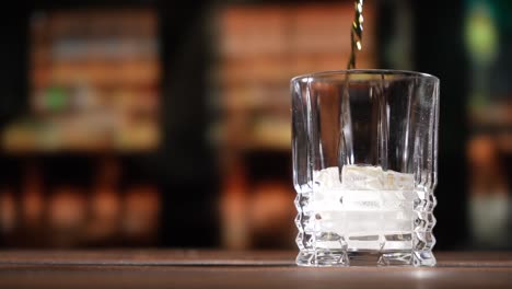 whiskey being poured into a glass in slow motion hd