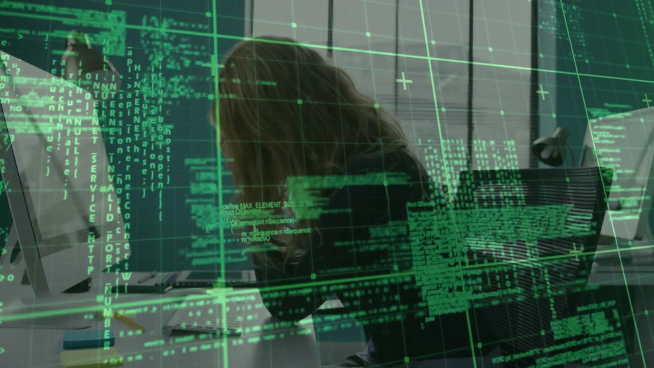 Woman typing and clicking at desk reviewing tech data while code overlay scrolling obscuring face