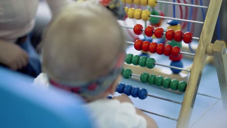 child plays with a multi-colored toy 2