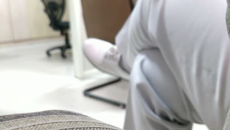 a-lady-officer-wearing-white-pant-or-trousers-and-white-shoes-related-to-uniform-sitting-with-crossed-legs-and-moving-legs-in-a-manner