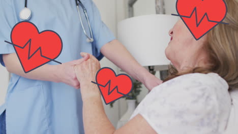 animation of hearts with cardiograph over caucasian female doctor and patient