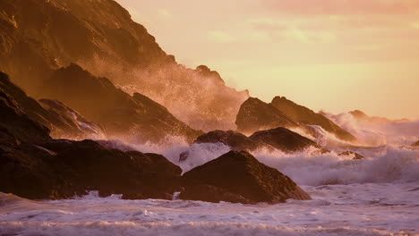 dangerous waves hitting the rocks in the coastline during sunset