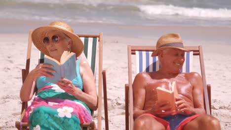 Senior-friends-sitting-in-beach-chair