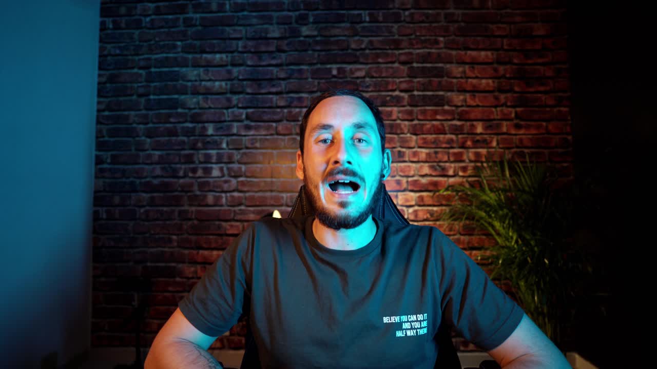 Youtube creator talking to camera with mixed color lighting
