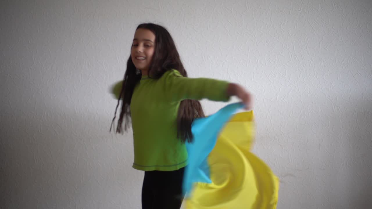 little girl holding the flag of Ukraine