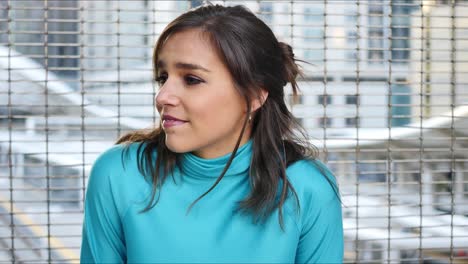 Bashful-woman-at-train-station-having-conversation-with-someone-out-of-frame