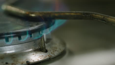 macro slow motion shot of a gas burner igniting and burning blue