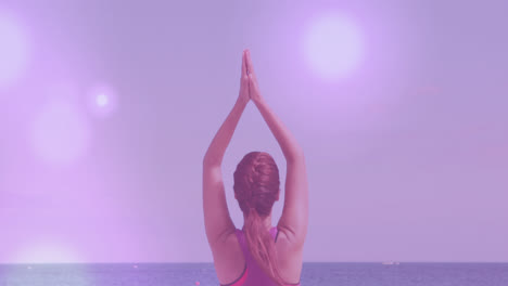 animation of spots over caucasian woman practicing yoga