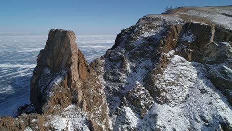 aerial view of cape khoboy, olkhon island. tall rocks in frozen lake baikal. popular touristic destination. winter landscape. panoramic view