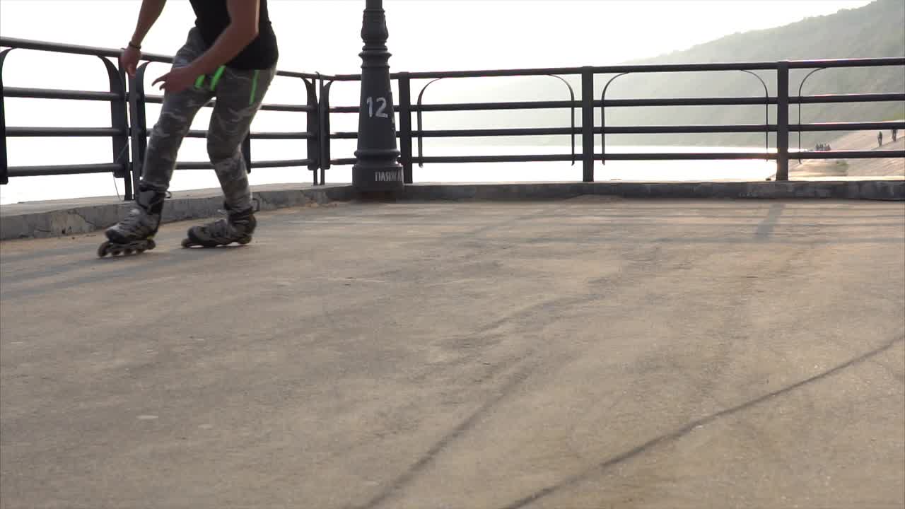 Person rollerblading on a pier by the ocean