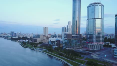 city skyline at dawn/dusk with riverfront