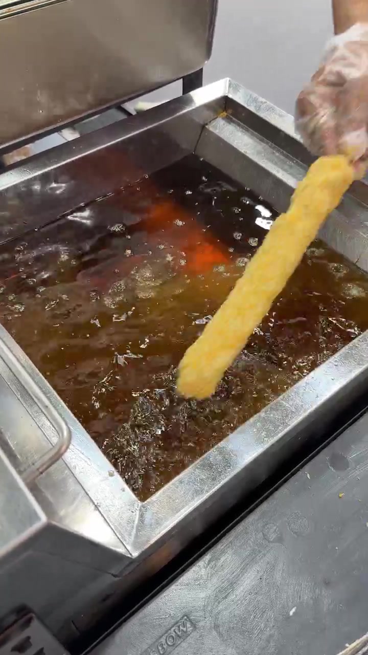 Chef Deep Frying Corn Dog in Commercial Kitchen