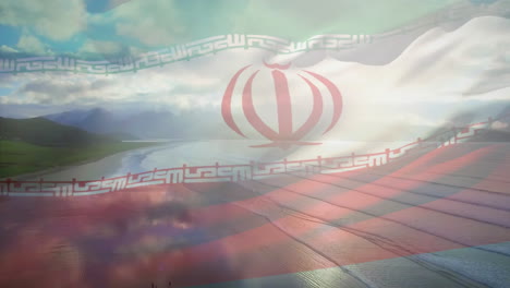 composición digital de ondear la bandera de irán contra la vista aérea de la playa y el mar