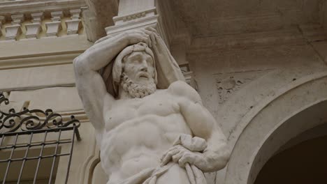close-up view of the statue of hercules at the entrance of bishops' palace in mantova, italy. low-angle