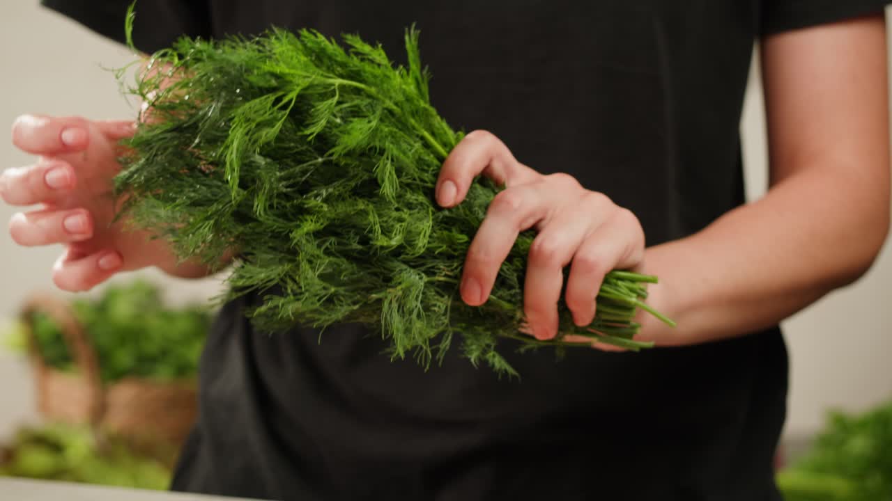 Cutting dill, chef cut dill with knife on a wooden board, close up at home, vitamin vegan greens.