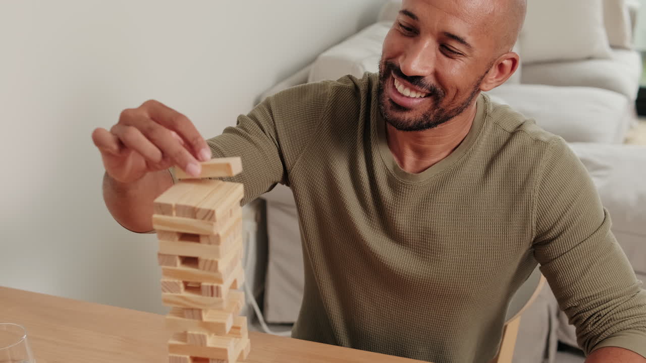 Mixed-race Couple Playing Jenga at Home