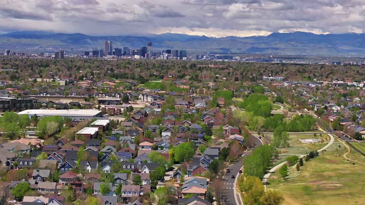 Front Range Denver Lowry Northfield Central Park Colorado aerial drone summer spring green blossom neighborhood condo apartment buildings sunny cloudy sky cars cityscape skyscrapers parallax right
