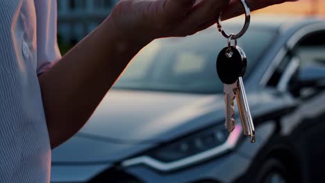 woman holding car keys at sunset