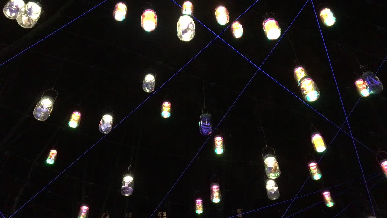 A night fixed scene where lots of glasses lanterns  geltly moving with the wind