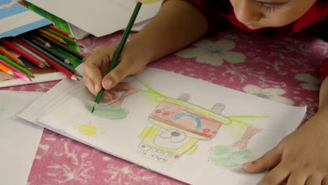 boy draws quietly lying in bedroom room at home