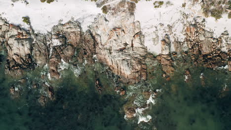 bird's eye view of waves splashing on rocky shore of britannia beach, st