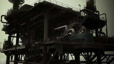 oil rig under moody skies during late evening offshore operations
